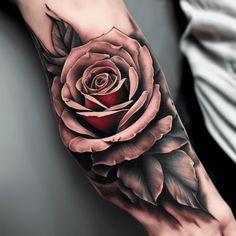 a rose tattoo on the right arm and left hand is shown in black and grey