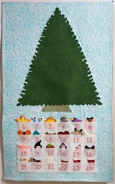 a calendar with a green christmas tree on it's wall hanging from the side