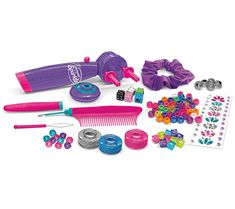 an assortment of toys and accessories are displayed on a white surface, including a hairbrush