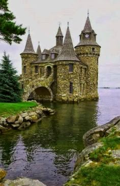 an old castle sitting next to a body of water