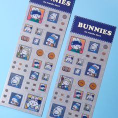 two stickers with cartoon characters on them sitting next to each other in front of a blue background