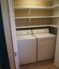 an empty washer and dryer in a small room