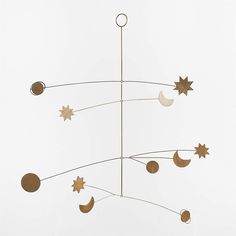 a metal wind chime with stars and moon shapes hanging from it's sides