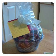 a basket filled with lots of different types of items on top of a wooden table