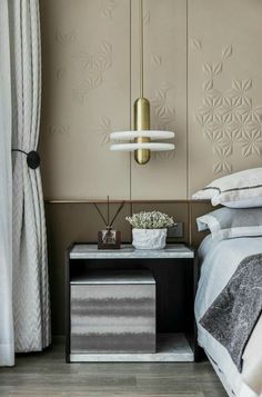 a bedroom with a bed, nightstand and lamp on the side table in front of it