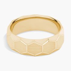 a yellow gold ring with geometric design