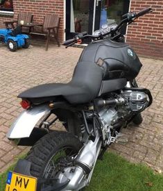 a motorcycle parked on the side of a brick road