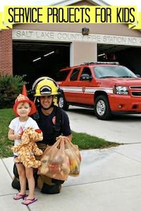 a fireman holding a child in front of a building with the words service projects for kids written on it