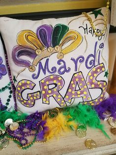 a mardi gras pillow sitting on top of a table