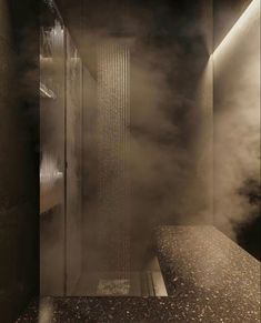 steam rises from the inside of a shower in a room with dark walls and flooring