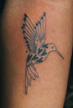 a bird with black spots on it's wings is shown in this tattoo design