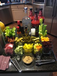 a kitchen counter topped with lots of different types of food and condiments on top of it