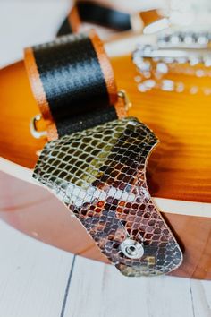 "These custom guitar straps are made of super durable 2\" seat belt webbing with leather tabs of reclaimed leather, rescued from New York City's garment district, with a layer of Kevlar sandwiched inside so you can be sure it's secure. Fits any guitar or bass with ease, and adjusts from 30-60\" in length to accommodate nearly any age or body type, with metal hardware    Strap is 2\" inches wide and adjusts to be 62\" inches long (measured from end to end).  (Additional lengths are available by c Leather Guitar Strap, Guitar Straps, Custom Guitar, Guitar Strap, Small Purse, Burgundy Color, Metal Hardware, Vintage Fabric, Seat Belt