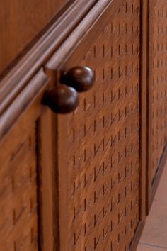 a close up of a wooden door with metal handles and knobs on the side