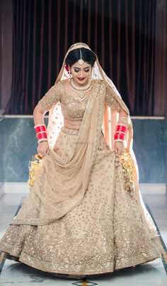 a woman in a bridal gown on the runway