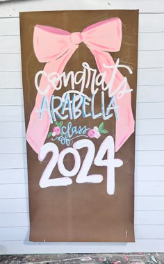 a sign on the side of a building that says congratulations arabella class of 202