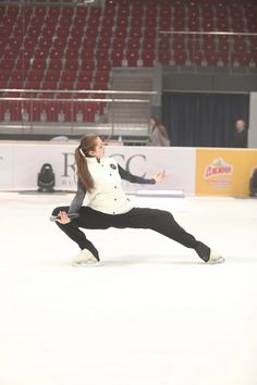 a woman is skating on an ice rink