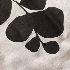 a black and white image of leaves on a piece of paper that has been cut out