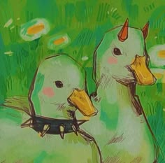 two ducks are sitting next to each other in the grass and one is wearing a cow's ear