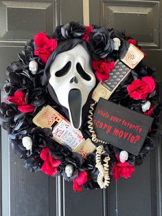 a wreath with a ghost mask and other items on it that says, what's your favorite scary movie?