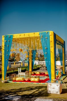 a yellow and blue tent set up for a wedding