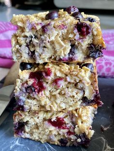 three granola bars stacked on top of each other with blueberries and oats