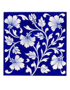 a blue and white tile with flowers on it