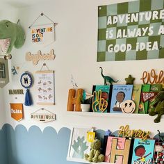 a child's room with books and toys on the shelf above it is decorated in green and blue