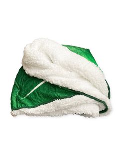 a green and white blanket laying on top of each other