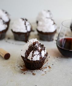 chocolate cupcakes with white frosting and wine