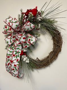 a christmas wreath with red and white bows