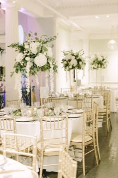 the tables are set with white flowers and greenery