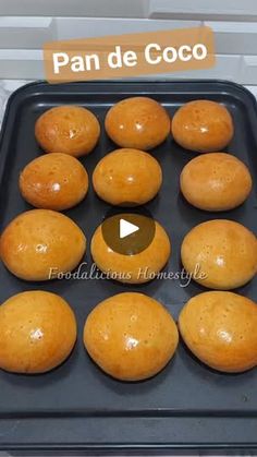 a pan filled with lots of doughnuts sitting on top of a counter