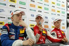 three men sitting at a table with microphones