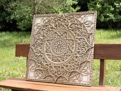 a wooden bench with an intricate design on it