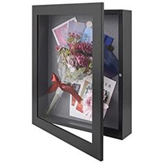 an open black box with flowers and pictures in the bottom half, on a white background