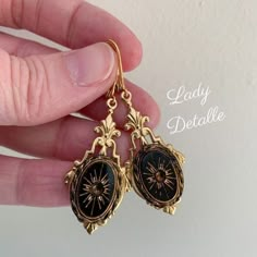 "Victorian SUN Intaglio Earrings, Gold and Black Intaglio, 16k gold plated brass lever backs, late 19th reproduction gold black earrings This listing is for a pair of reproduction late 19th century VICTORIAN design earrings, created with a gorgeous GOLD and Black GLASS intaglio in a historic and classical SUN design, finished with 16K gold plated brass Lever backs. I simply adore this classic Victorian design: perfect for your late 19th century re-enactments: versatile and lovely design and dang Sun Design, Victorian Design, Black Earrings