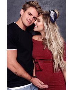 a young man and woman are posing for a photo with their heads wrapped around each other