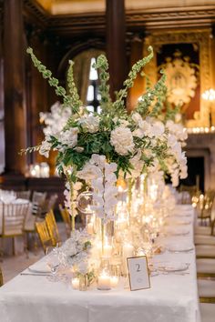 the centerpieces are filled with flowers and candles