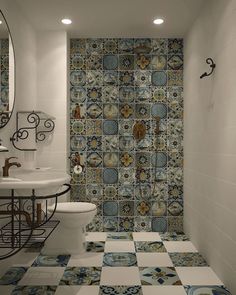 a bathroom with blue and white tiles on the floor