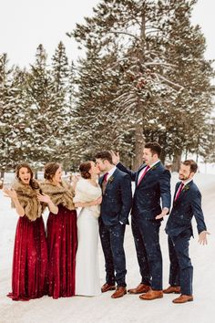 a group of people standing next to each other in the snow