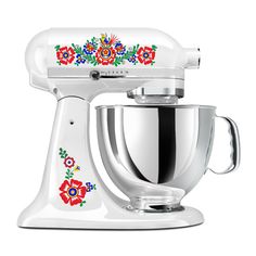 a white mixer with flowers painted on it