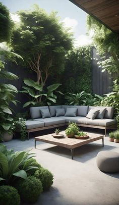 an outdoor living area with couches, tables and potted plants