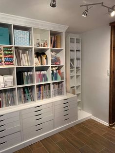 a room with many bookshelves and drawers on the wall next to each other