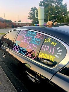 a car parked on the side of the road with writing on it's windshield