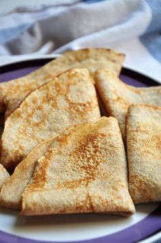 some pancakes are on a purple and white plate