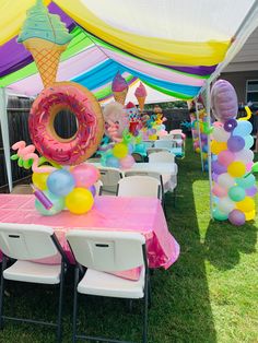 an outdoor party setup with balloons, decorations and tables for children's birthdays