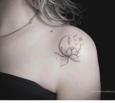 a woman's shoulder with a flower tattoo on it