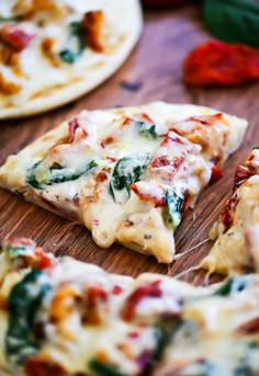 several slices of pizza sitting on top of a wooden cutting board