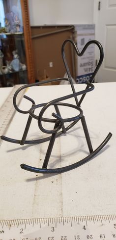 a metal heart shaped object sitting on top of a table